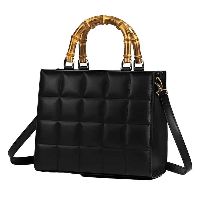 Black quilted handbag with gold bamboo handle on a white background
